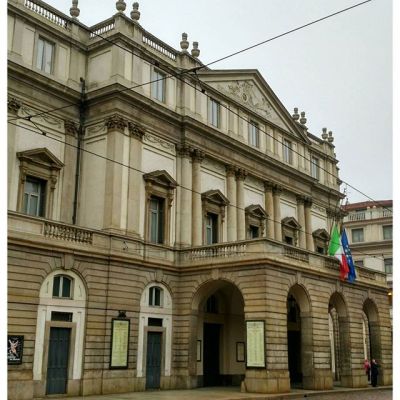 Театр Ла Скала. Хотела попасть на мероприятие, посвящённое истории театра и величайшим голосам, но уже за час там стояла большая очередь и я решила, что у меня не настолько много времени в Милане, чтобы проводить его в толкучке. Флаги приспущены - траур. #театр #ласкала #theatre #lascala #milano #milan #italy #italia